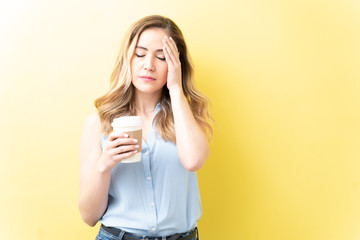 Stressed Woman With Coffee Over Colored Background