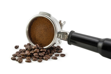 Roasted coffee beans and ground coffee in porta filter holder isolated on white background including clipping path.