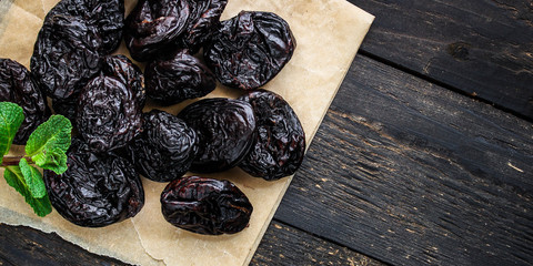 prunes, dried plums (tasty and healthy fruits) desiccated keto or paleo diet menu concept. background. top view. copy space