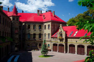Obraz premium An ancient fire department, a building in the style of a medieval castle. Inner courtyard. European streets with paving stones. A city for romantic people and lovers. Lviv, Ukraine, July 18, 2017