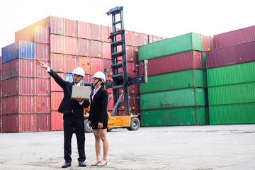 Male and Female Industrial Engineers Talk with Factory Worker while Using Laptop. They Work at the Heavy Industry Manufacturing Facility.