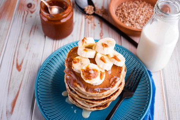 Delicious and lush pancakes with fresh fruits and berries, poured with salted caramel.