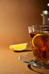 glass cup of green tea with lemon close-up on a brown background vertical orientation