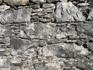 Stone wall texture or stone background with grey stones