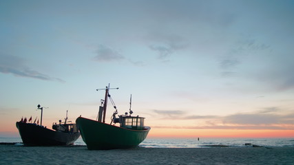 Scenic Seascape Video: Two Fishing Boats Morred to Shore Beach at Beautiful Vanilla Sunset over Sea in Summer
