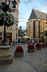 An ancient European narrow street with cobblestone. Old plastered colored facades of houses. Romantic cozy streets. Medieval Europe. Lviv, Ukraine, July 18, 2018