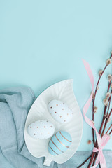 Easter background with Easter eggs in bird nest on blue background