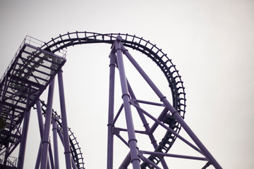 A roller coaster in an amusement park. Relax in fun amusement. Fun for the townspeople. Rail-type metal construction for accelerating the trolley. Fun in the amusement park.