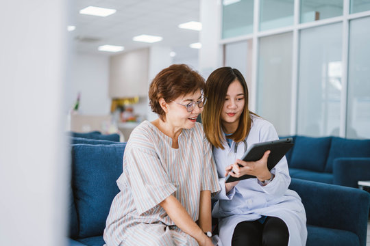 Young doctor consulting senior patient at health care clinic 
