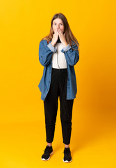 Student ukrainian teenager girl over isolated yellow background with surprise facial expression