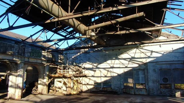Rising Aerial Shot Through an Abandoned Factory Roof