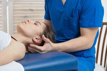 The woman is lying on the couch, and the doctor makes a diagnosis of the occipital part of the...