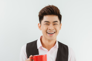 Portrait Handsome Asian boy holding coffee cup over white background