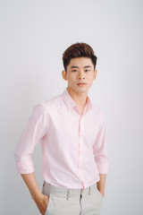 Portrait of good looking asian man over white background.