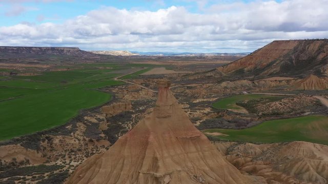 Bardenas Reales castil de tierra aerial shot spring time green grass in background cloudy day aerial Spain