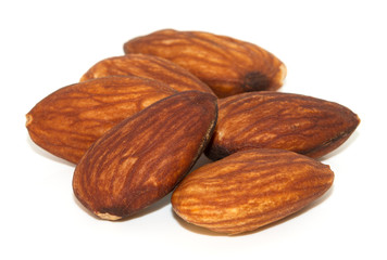 Group of almonds with leaves isolated on white background