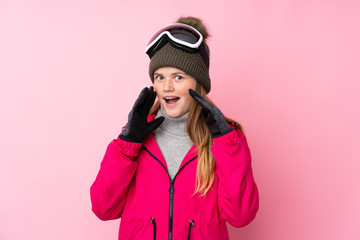 Ukrainian teenager skier girl with snowboarding glasses over isolated pink background shouting with mouth wide open