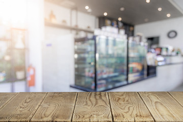 wooden tables for placing products on the blurry background of cafes. Empty wooden counter in blur white coffee shop for mockup, banner, template