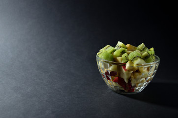 sliced fruit in a glass vase on a grey background horizontal orientation