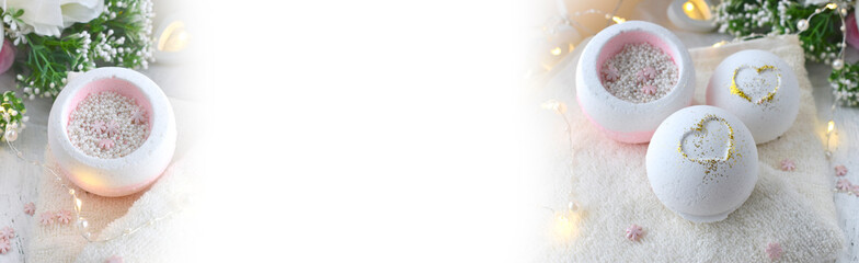 Bath bombs with roses, heart, towel on light background. Spa lifestyle resort concept for...