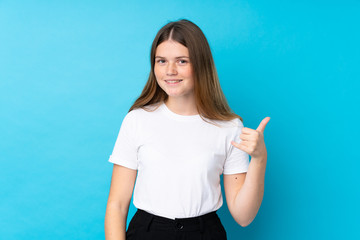 Fototapeta premium Ukrainian teenager girl over isolated blue background making phone gesture