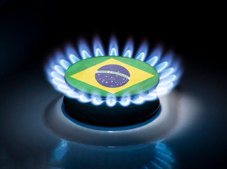 Burning gas burner of a home stove in the middle of which is the flag of the country of Brazil. Gas...