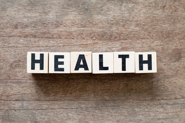 Fototapeta premium Letter block in word health on wood background