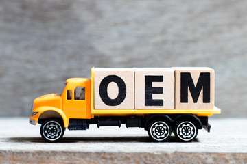 Truck hold letter block in word OEM (Abbbreviation of Original Equipment Manufacturer) on wood...