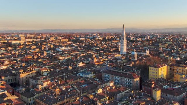 aerial shot drone of modena at sunset flying over city center sideways