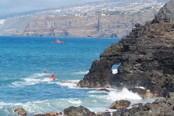 Red lifeboat and jet skis in Atlantic ocean, Tenerife island