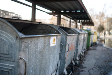 Fototapeta na wymiar Garbage containers in row on the urban street.
