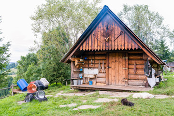 Wooden shepherd's hut in the mountains on a hillside