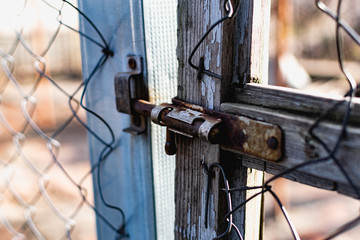 Old vintage door handles. Rusty metal locks and latches. Protective devices for wooden yard gates