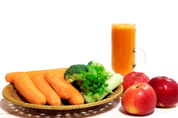 Fresh carrot juice. Vegetables on a wooden table. Healthy, vegetarian food. Natural vitamins. Carrot, broccoli and celery.