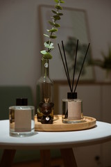 Decorative, moisturizing and aromatherapy concepts - aromatic reed diffusers, on a table at home