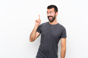 Young handsome man over isolated white background intending to realizes the solution while lifting...