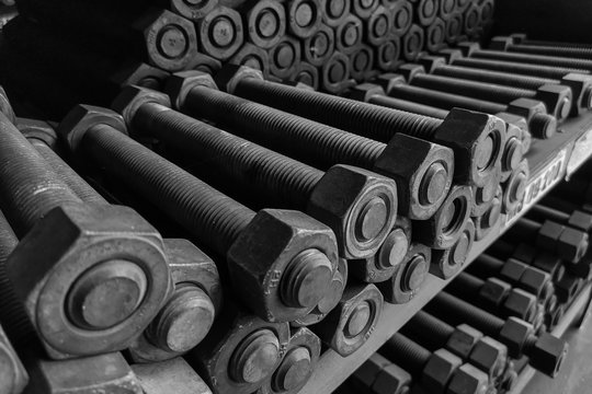 Hard metal material nut an bolt on shelf for heavy industry machinery at factory inventory.