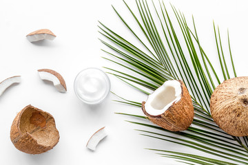 Fototapeta na wymiar Skin care cream with coconut oil on white background top-down
