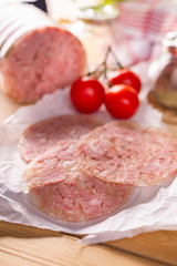 Sliced headcheese on a paper. Brawn. Pork cold cuts.