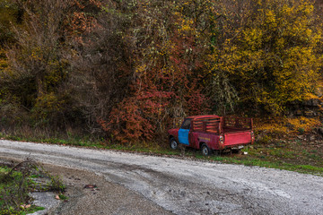 Old ruined car aside of the country road