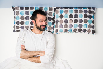 Man in bed in top view happy and smiling