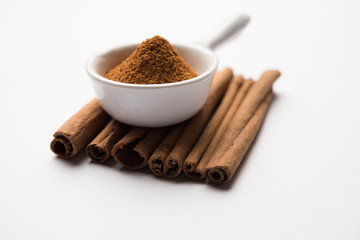 Powder cinnamon and sticks also known as Dalchini or Dalcheenee masala from India, selective focus