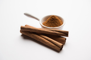 Powder cinnamon and sticks also known as Dalchini or Dalcheenee masala from India, selective focus
