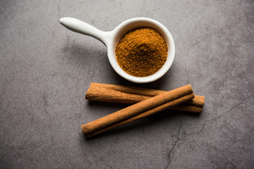 Powder cinnamon and sticks also known as Dalchini or Dalcheenee masala from India, selective focus