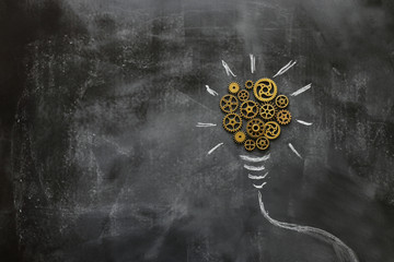Education concept image. Creative idea and innovation. Vintage gears light bulb metaphor over...