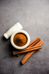 Powder cinnamon and sticks also known as Dalchini or Dalcheenee masala from India, selective focus