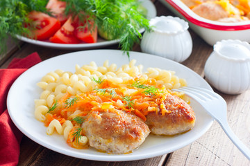 Baked homemade meat patties with pasta on a white plate, selective focus