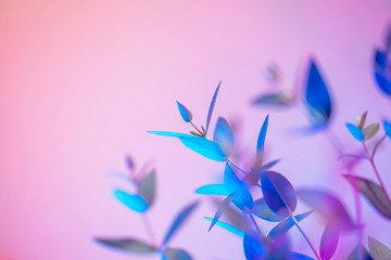Light neon background with leaves. Glowing botanical backdrop with shiny gradients on petals....