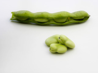 green beans in pods on a white background