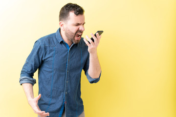 Aggressive Hispanic Man Is Using Mobile Phone